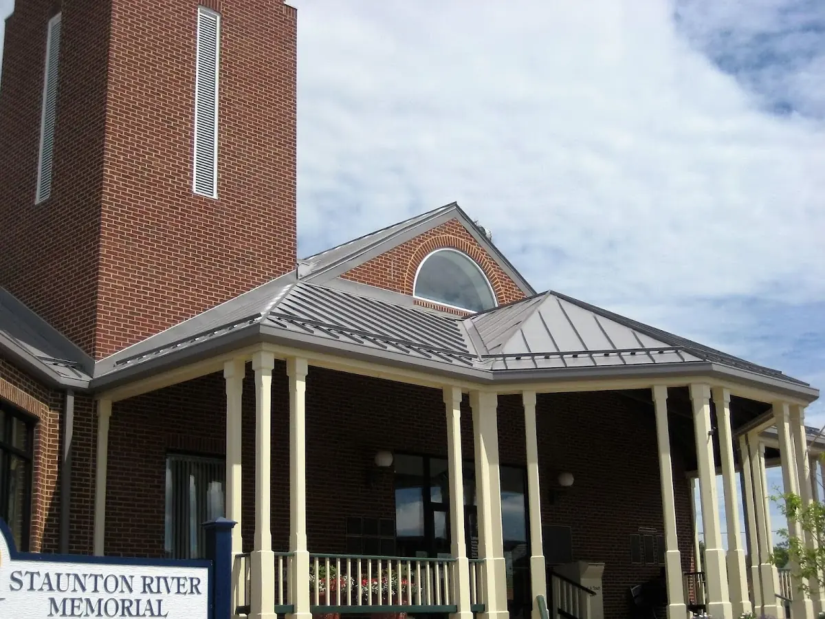 Skilled roofing craftsmen working on a residential roof in Hiland